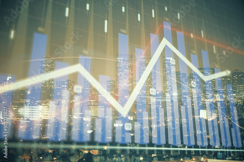 Financial graph on night city scape with tall buildings background multi exposure. Analysis concept. © peshkova