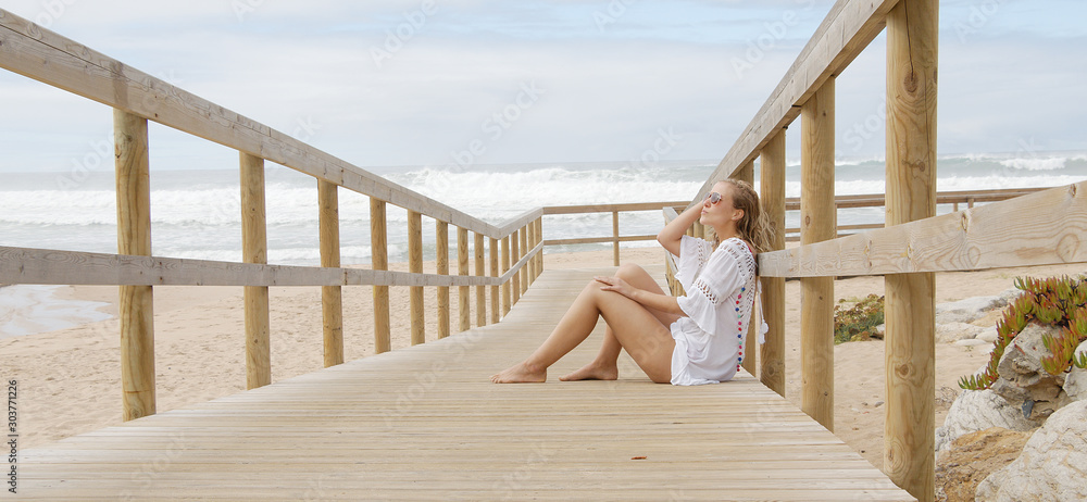 Sexy girl poses for the camera - happy girl on summer vacation at the beach - travel photography