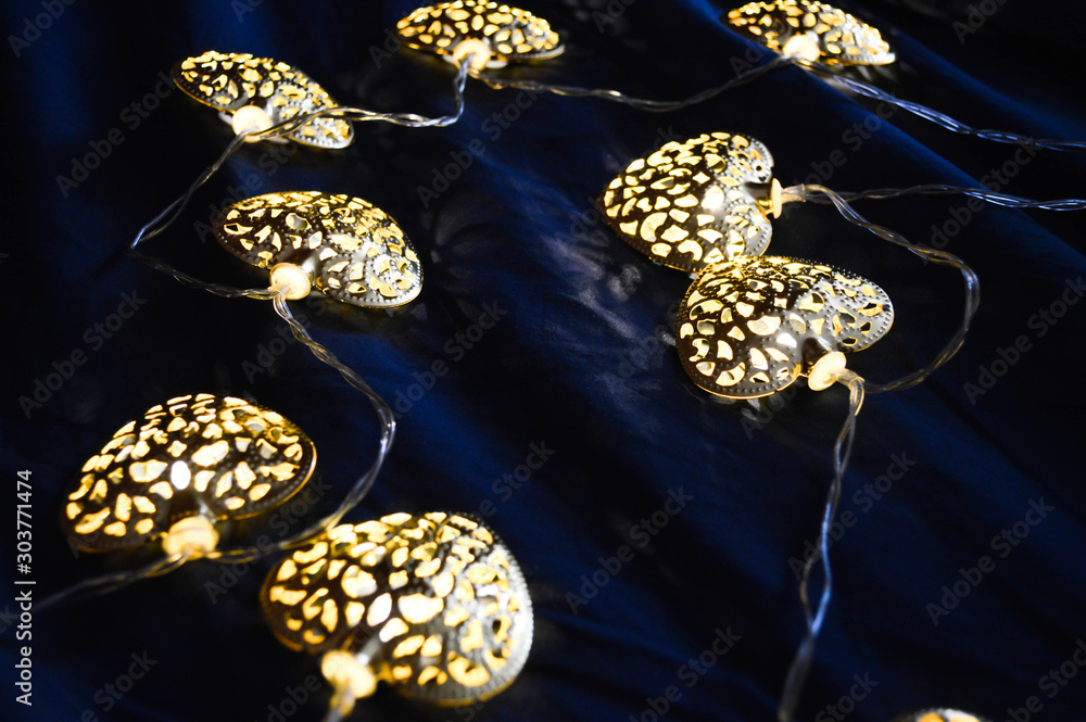 Decor garlands of lamps on blue texture background Decor garlands of lamps on blue texture background