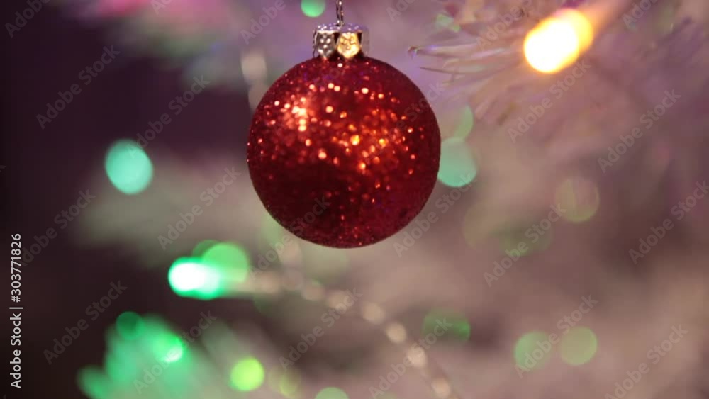 Christmas interior. Decoration of a white Christmas tree with red toys. Decorating on Christmas tree with ball. Dresses Christmas tree with ball lights. Christmas interior. Decoration of a white Christmas tree with red toys. Decorating on Christmas tree with ball. Dresses Christmas tree with ball lights.