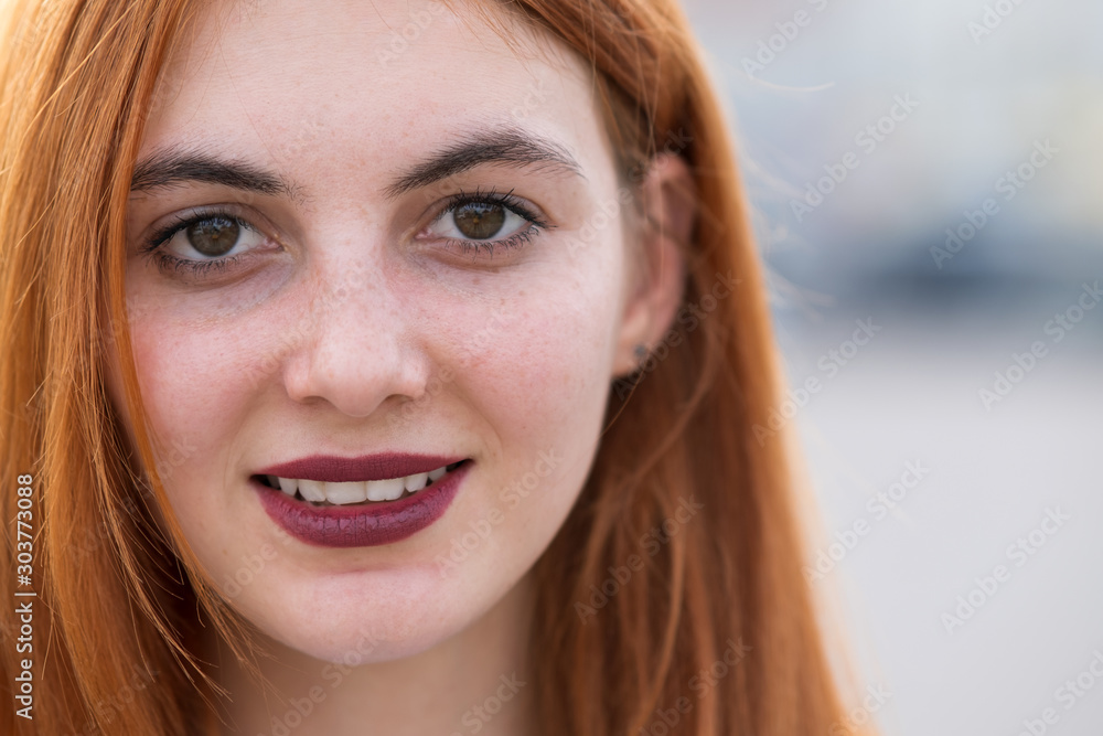 Closeup face portrait of a girl with red hair and clear eyes. Closeup face portrait of a girl with red hair and clear eyes.