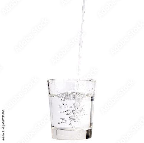 Pour water into a glass isolated with clipping path included.
