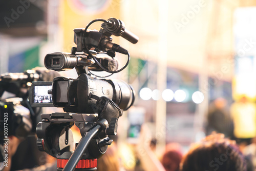 Professional video camera with abstract blurred background