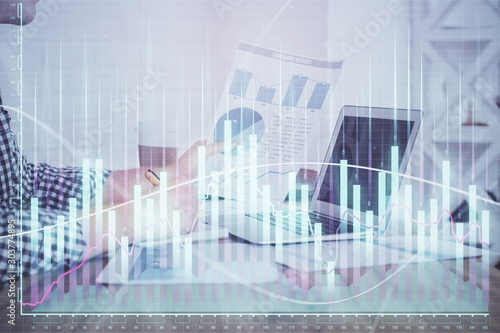 Multi exposure of financial graph with man works in office on background. Concept of analysis.