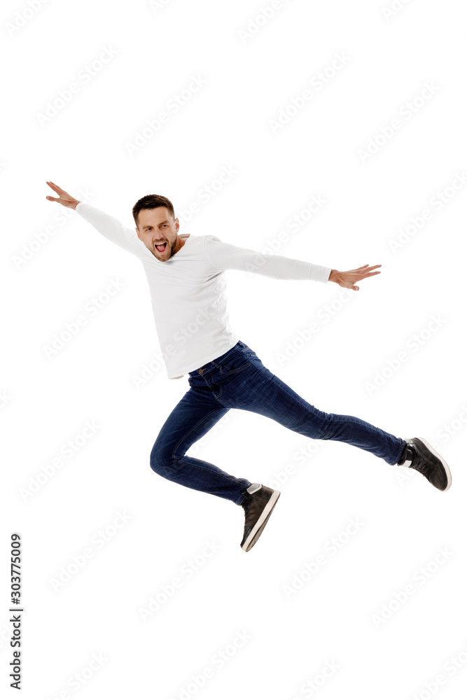 handsome young bearded man jumping. Full length portrait over white background