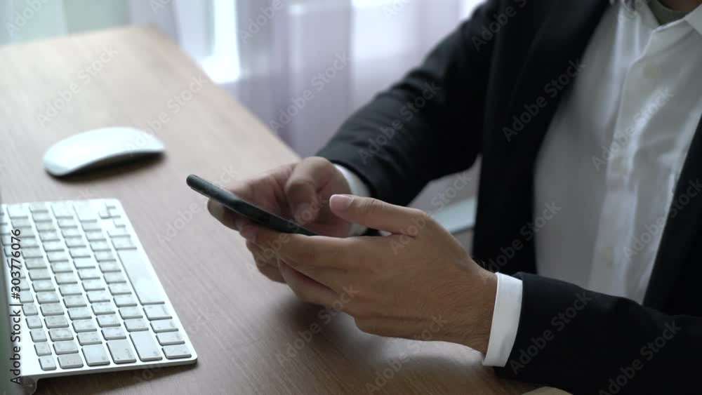 Close-up hand of businessman using smartphone Close-up hand of businessman using smartphone
