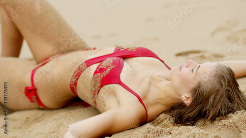 Sexy view at the beach - skin covered with sand - travel photography