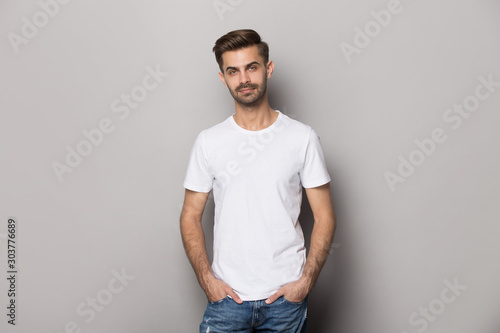 Portrait with smiling handsome bearded man in white t-shirt.