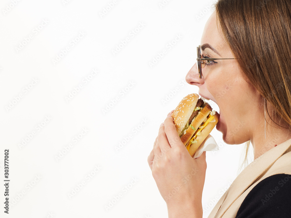 girl eating a burger on a white background girl eating a burger on a white background