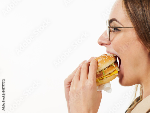 girl eating a burger on a white background