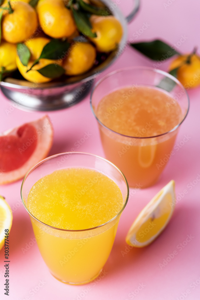 Composition with Two Glasses of Assorted Citrus Juices Detox Diet Healthy Drink Mandarine Lemon and Grapefruit Juices Raw Mandarines Pink Background Vertical Composition with Two Glasses of Assorted Citrus Juices Detox Diet Healthy Drink Mandarine Lemon and Grapefruit Juices Raw Mandarines Pink Background Vertical