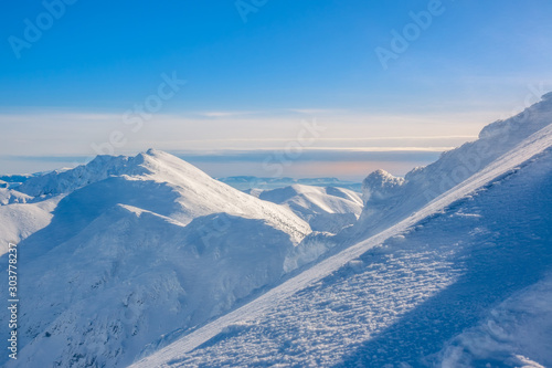 Steep Ski Trail on the Background of Mountain Peaks