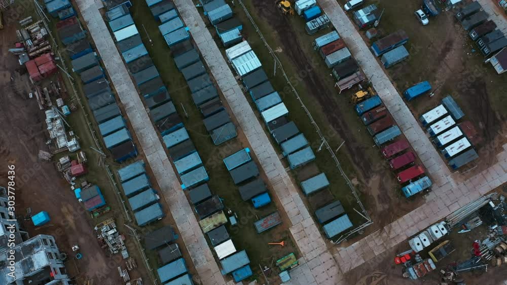 Drone fly above town of red and blue prefabricated lodges for construction workers and watchmen, development process of high rise block of flats. Drone fly above town of red and blue prefabricated lodges for construction workers and watchmen, development process of high rise block of flats.