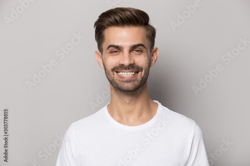 Close up portrait with smiling broadly handsome bearded man. © fizkes