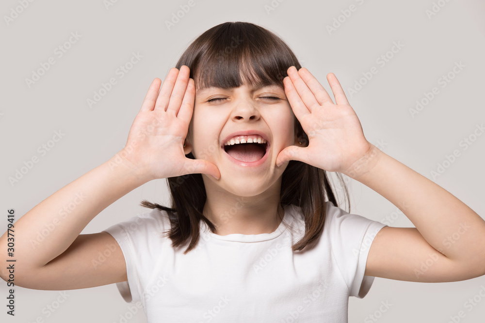 Close up portrait with screaming little brown-haired girl. Close up portrait with screaming little brown-haired girl.
