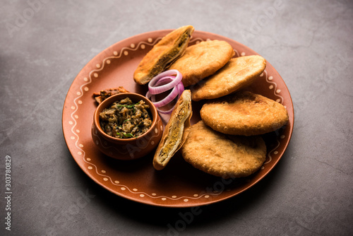 Fried Sattu Litti chokha served with Baingan Bharta, onion and pickle, popular recipe from Bihar, India photo