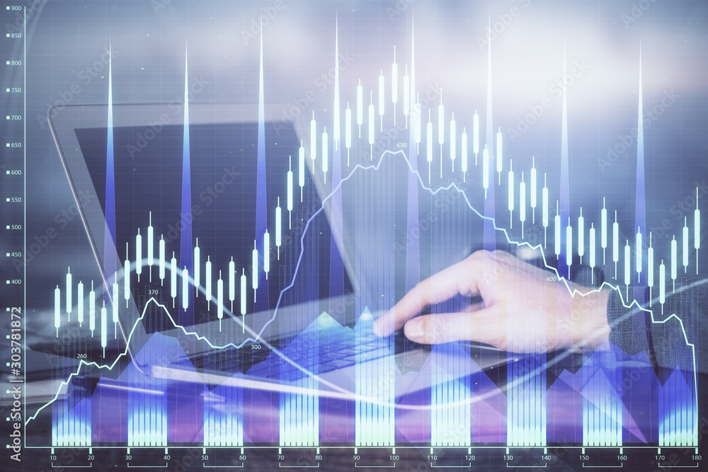 Double exposure of man's hands writing notes with laptop of stock market with forex graph background. Top View. Concept of research and trading. Double exposure of man's hands writing notes with laptop of stock market with forex graph background. Top View. Concept of research and trading.
