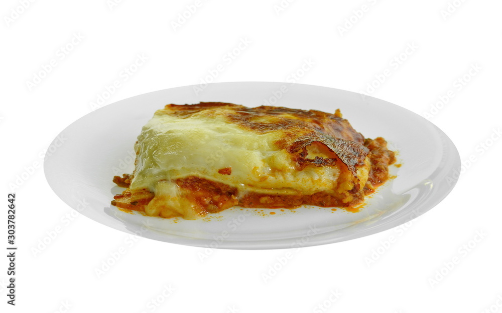 Portion of tasty lasagna. An isolated traditional lasagna made with minced beef bolognaise sauce. Tasty serving of traditional Italian lasagne with spicy tomato based ground beef and melted mozzarella