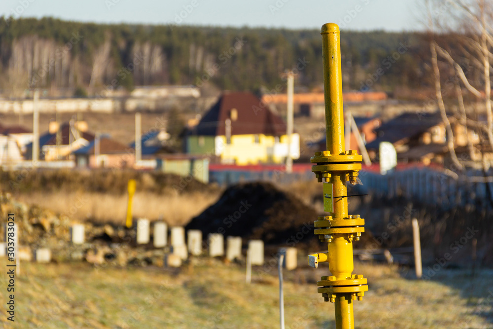 vertical gas pipeline with tap for turning on and off the supply of gas on free territory in a cottage village