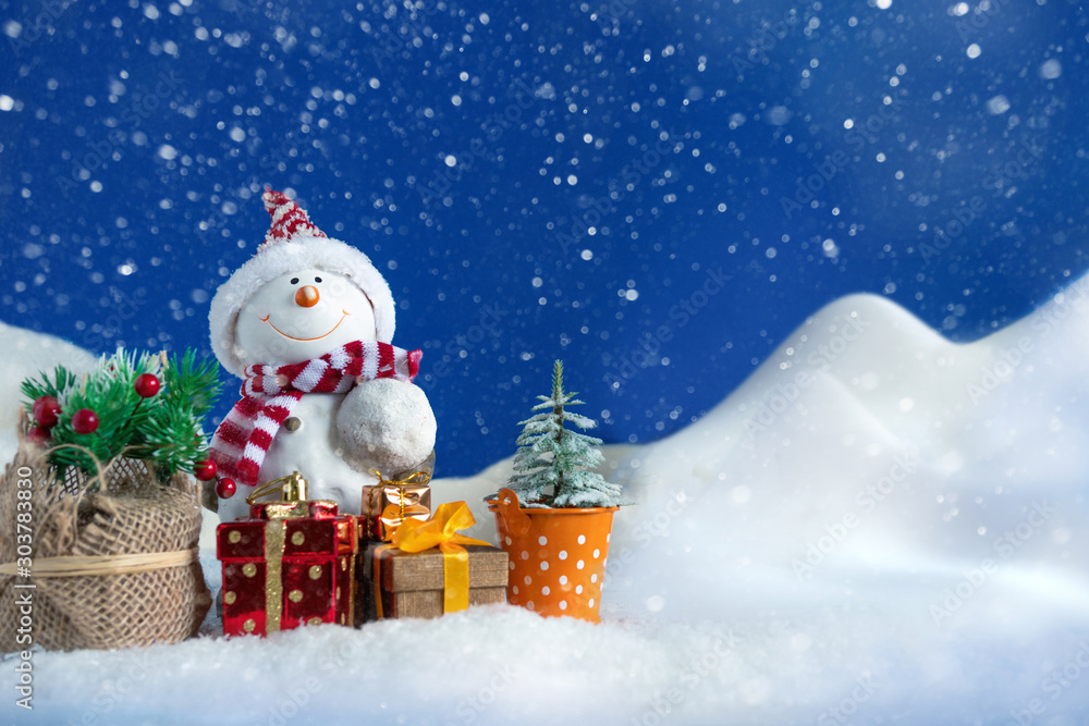 Snowman in a snowdrift with gifts for Christmas and New year