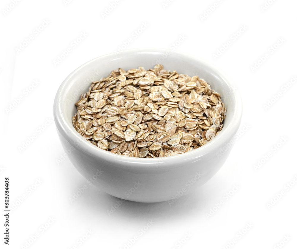 Rye oat flakes in a white bowl isolated on white background.