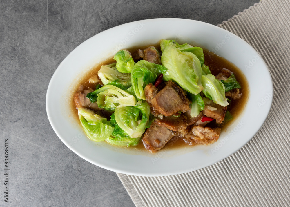 Stir Fried Baby Cabbage with Crispy Pork on plate , Asian Food Stir Fried Baby Cabbage with Crispy Pork on plate , Asian Food