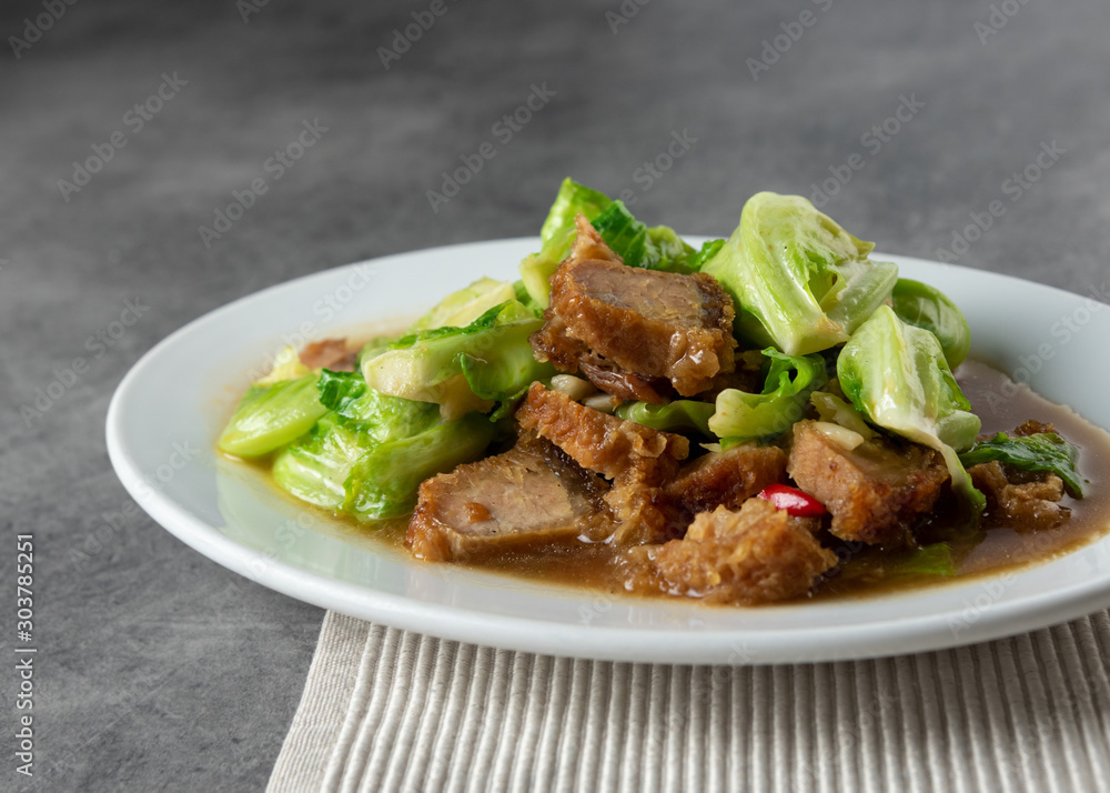 Stir Fried Baby Cabbage with Crispy Pork on plate , Asian Food