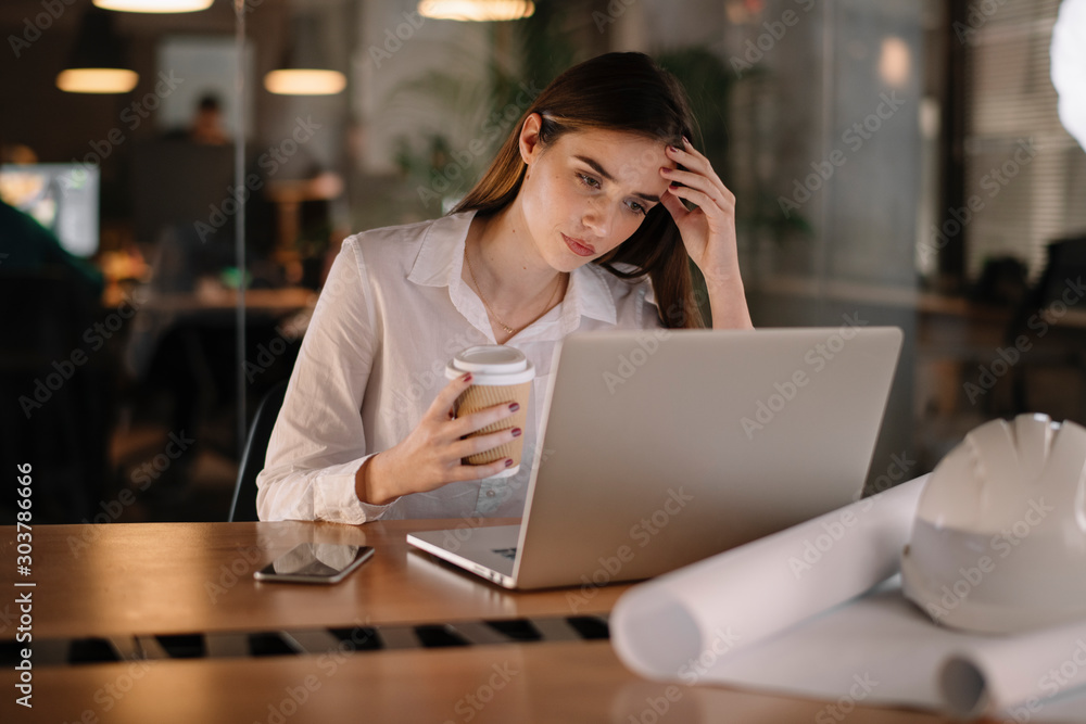 Portrait of tired businesswoman. Young businesswoman working late night Portrait of tired businesswoman. Young businesswoman working late night