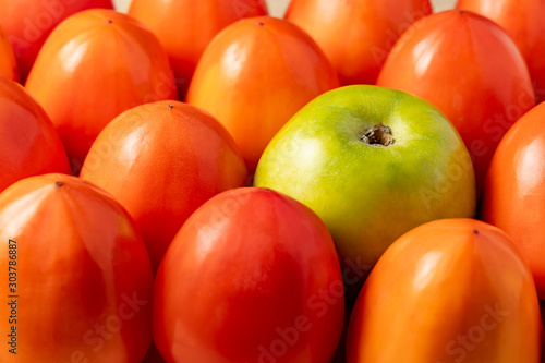 Fototapeta Naklejka Na Ścianę i Meble -  Juicy persimmons and green apple close-up.