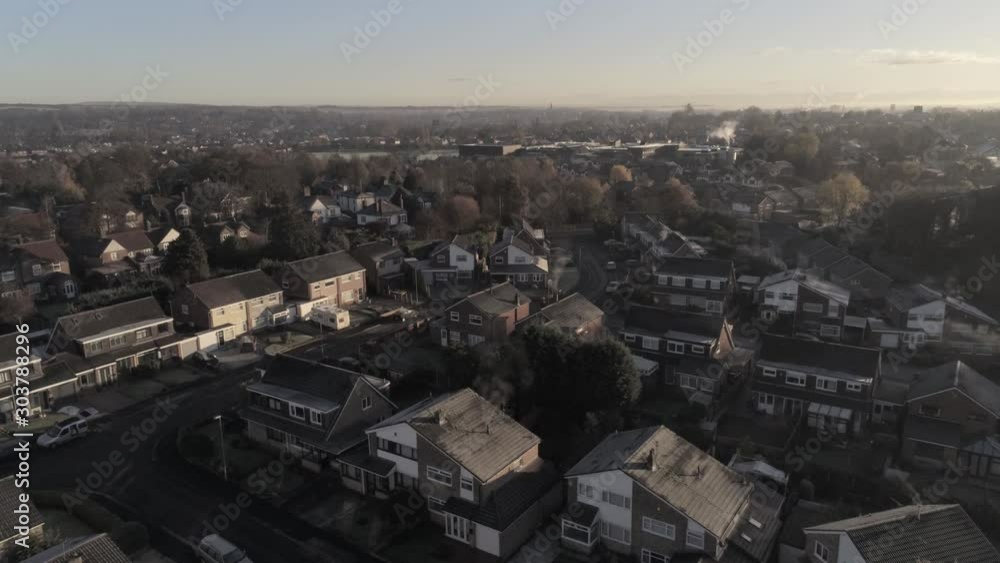 Aerial view above UK town, village rooftops Autumn frost scenic view. Rising tilt down view. Aerial view above UK town, village rooftops Autumn frost scenic view. Rising tilt down view.