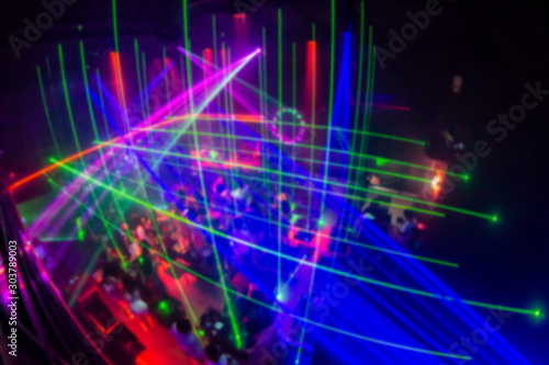 Abstract blur laser And Silhouette hands of audience crowd people enjoying the club party with concert. Blurry night club DJ party people enjoy of music dancing sound.for Background.