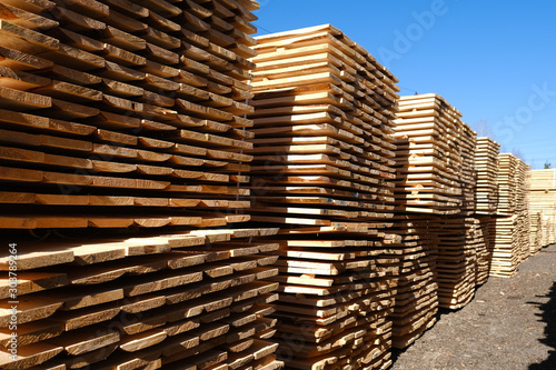Wood timber in the sawmill. Piles of wooden boards in the sawmill. 