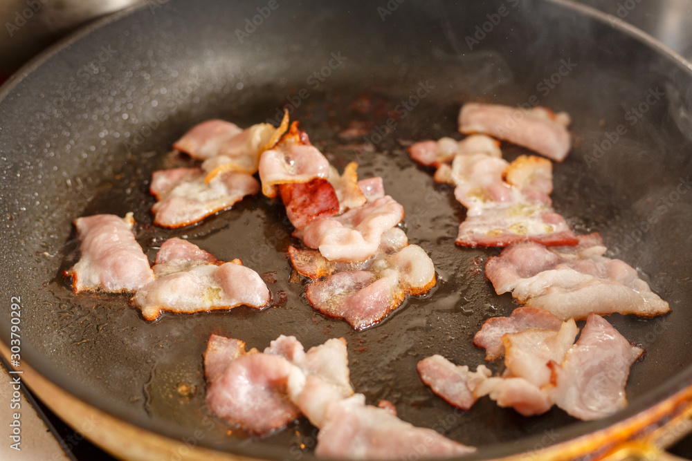 bacon fried in a pan bacon fried in a pan