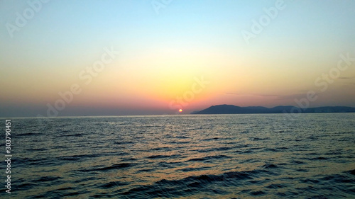 Sunset over the beautiful blue sea
