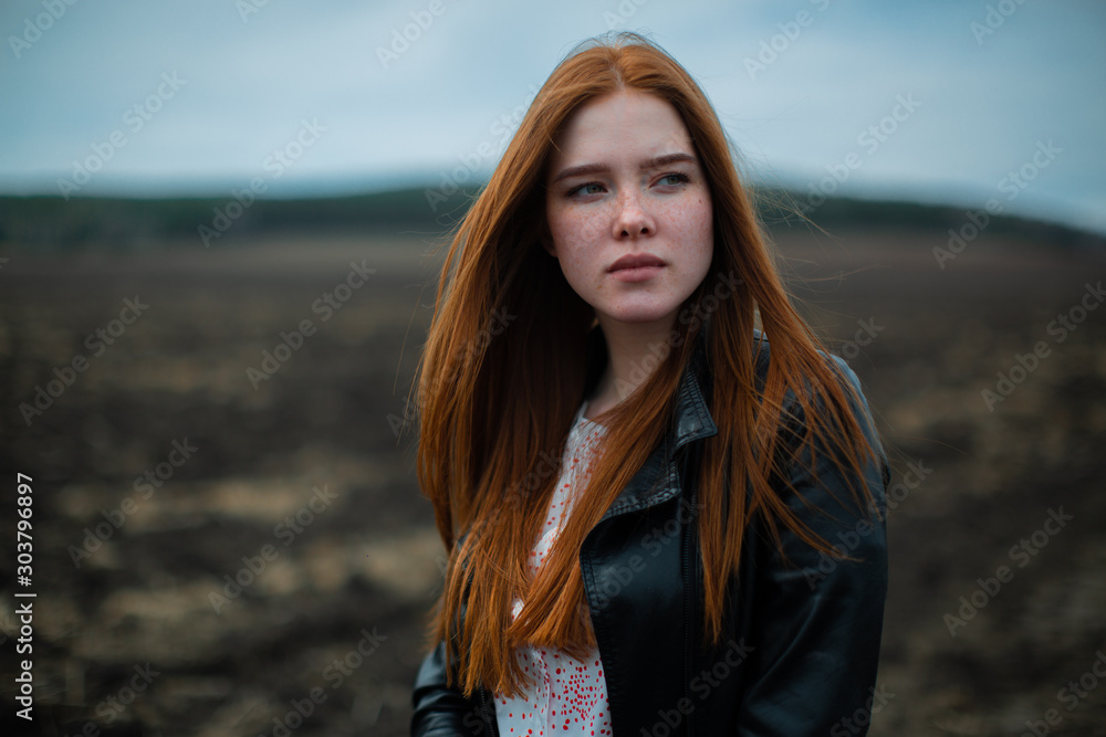 Fiery red beauty on the background of a desert mountain landscape. Fiery red beauty on the background of a desert mountain landscape.