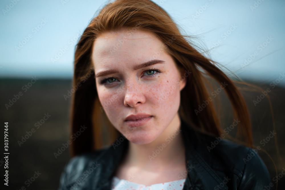 A beautiful young woman stares into the camera.