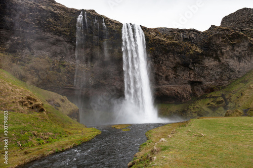 Famous Iceland waterfalls with a clean water on a stony rocky mountain landscape © strannik_fox