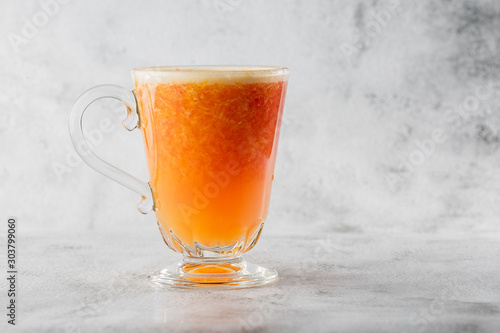 Glass of fresh orange fruit juise isolated on bright marble background. Overhead view, copy space. Advertising for cafe menu. Horizontal photo. photo