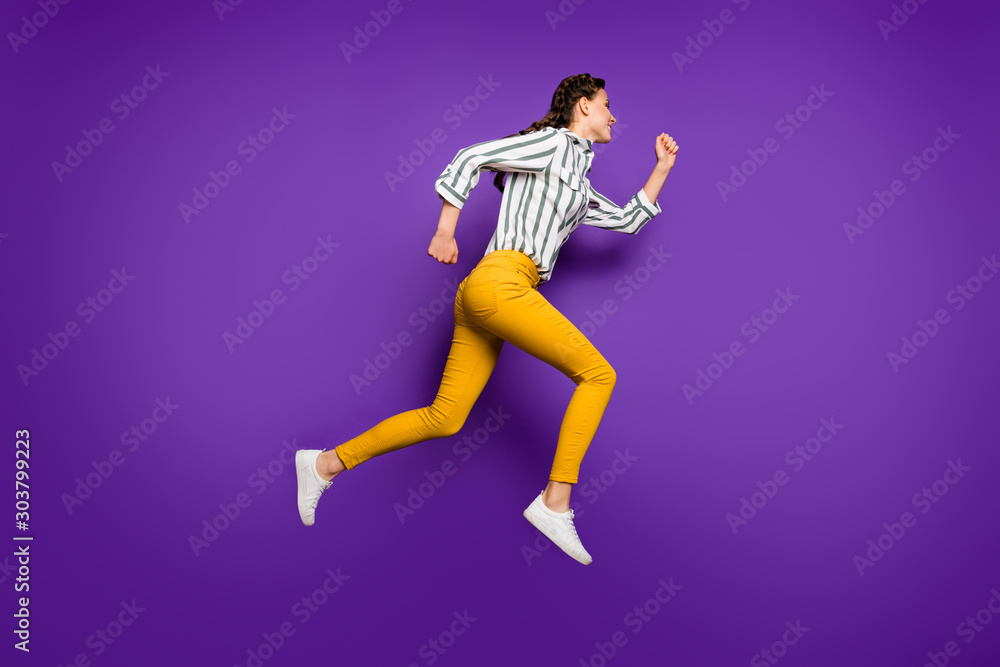 Full body profile photo of pretty lady jumping high rushing discount sale prices shopping wear striped shirt yellow trousers isolated purple color background