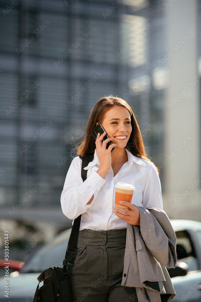 Beautiful businesswoman outdoors. Young woman on coffee break. Beautiful woman talking on smart phone. Beautiful businesswoman outdoors. Young woman on coffee break. Beautiful woman talking on smart phone.
