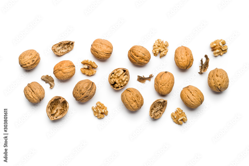 top view of walnuts closed and broken scattered on a white background with copy space top view of walnuts closed and broken scattered on a white background with copy space