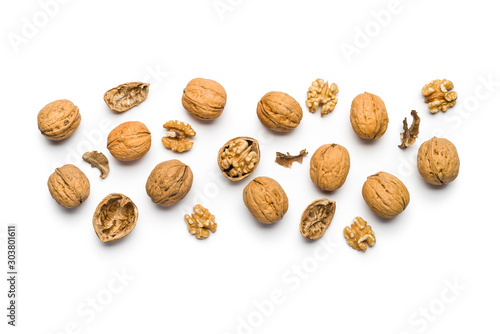 top view of walnuts closed and broken scattered on a white background with copy space photo