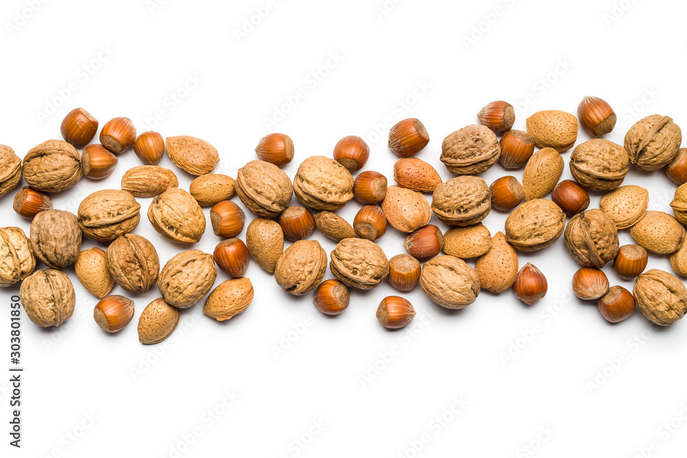 top view of mix of nuts scattered on white background with copy space top view of mix of nuts scattered on white background with copy space