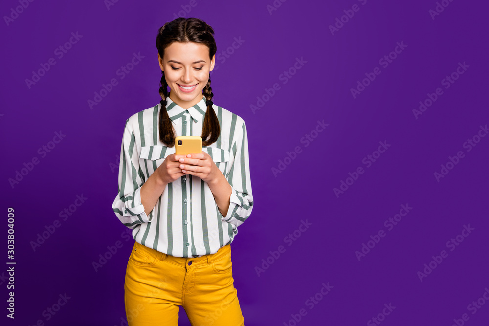 Photo of beautiful lady holding telephone writing new instagram post positive good mood wear striped shirt yellow trousers isolated purple color background Photo of beautiful lady holding telephone writing new instagram post positive good mood wear striped shirt yellow trousers isolated purple color background