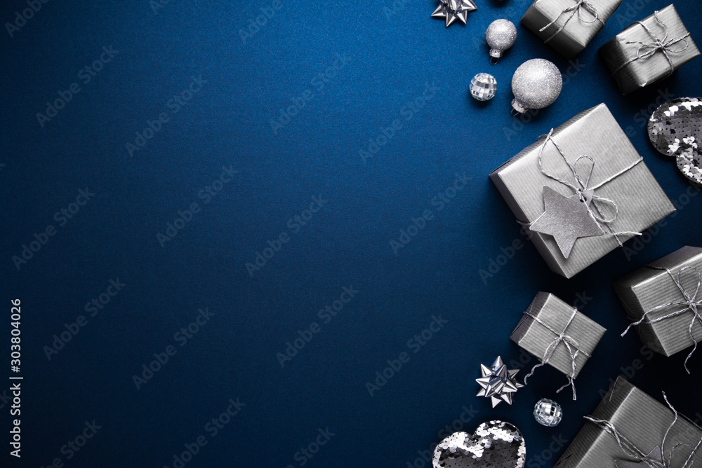 Merry Christmas ornaments and gift on blue background top view. Xmas and new year holiday theme. Flat lay Merry Christmas ornaments and gift on blue background top view. Xmas and new year holiday theme. Flat lay