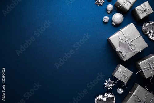 Merry Christmas ornaments and gift on blue background top view. Xmas and new year holiday theme. Flat lay 