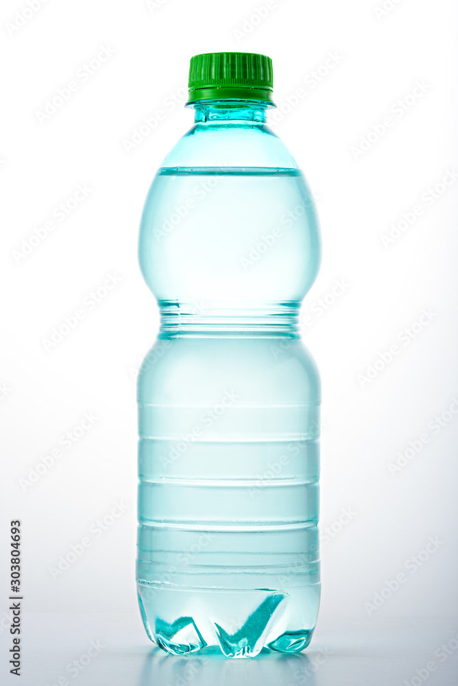 vertical image of plastic bottle with green lid filled with water on white background vertical image of plastic bottle with green lid filled with water on white background