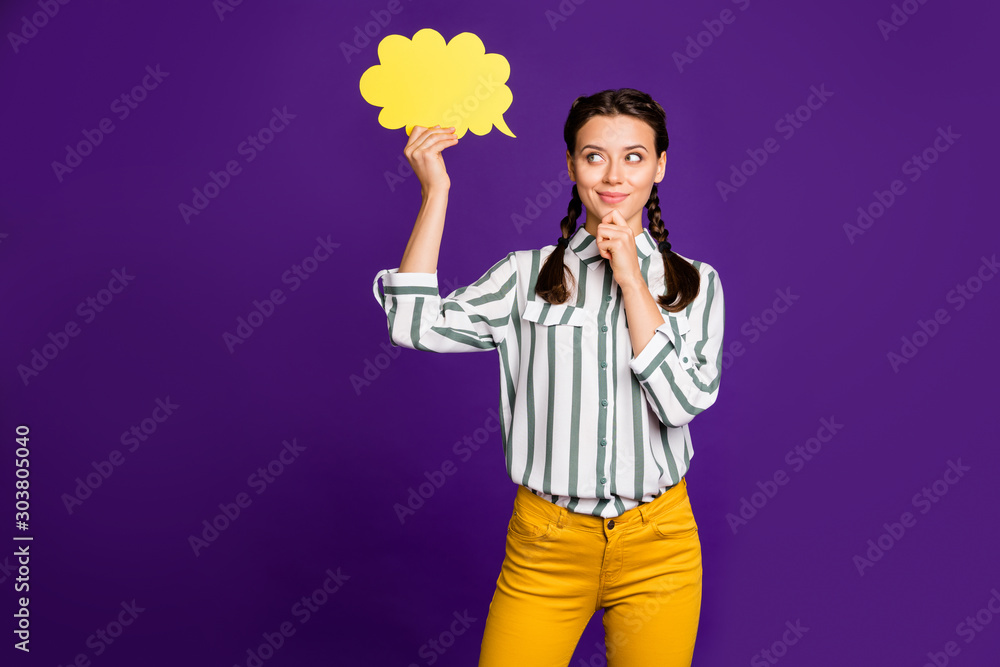 Photo of attractive lady hold paper mind cloud think over creative dialogue answer hand on chin wear striped shirt yellow trousers isolated purple color background Photo of attractive lady hold paper mind cloud think over creative dialogue answer hand on chin wear striped shirt yellow trousers isolated purple color background