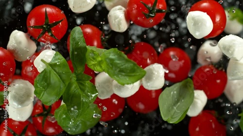 Super Slow Motion Shot of Flying Caprese Salad on Black background at 1000fps. photo