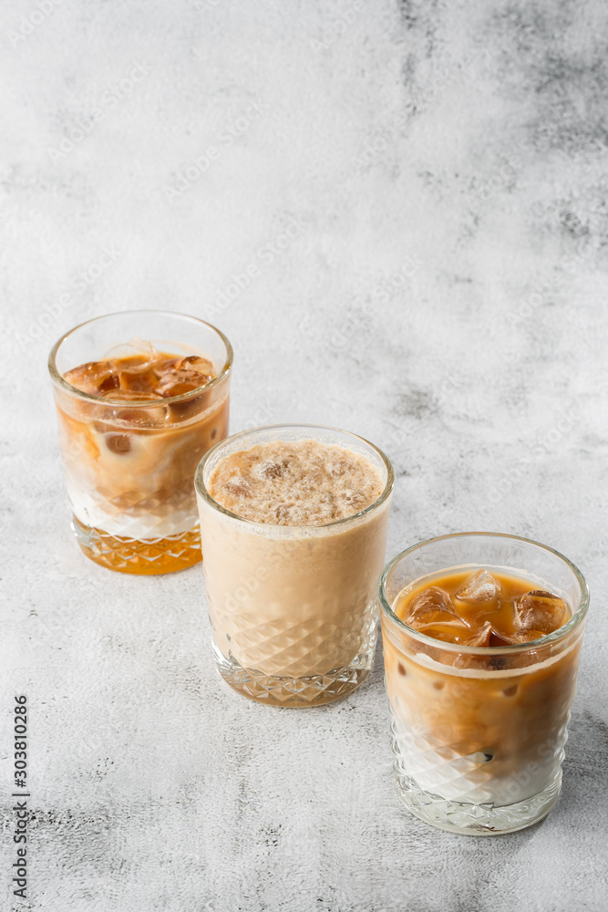Φωτογραφία Three glasses with cold brew coffee and milk and ice cocoa isolated on bright marble background